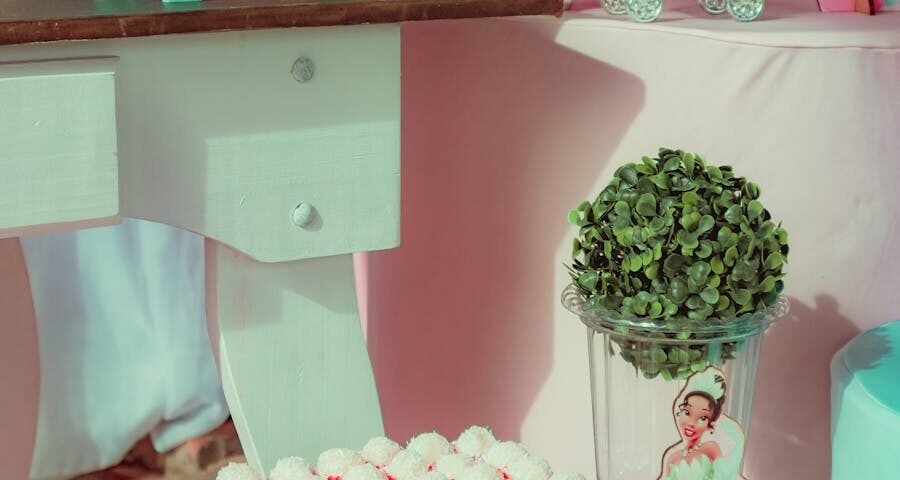 A delightful pink and teal princess-themed party setup with sweets and decorations.