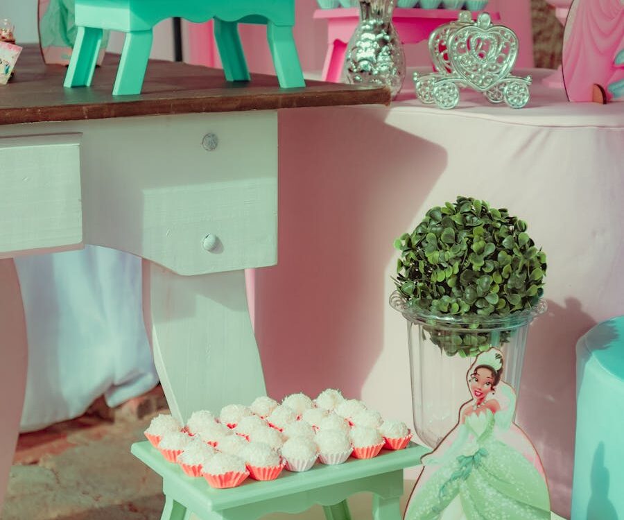 A delightful pink and teal princess-themed party setup with sweets and decorations.