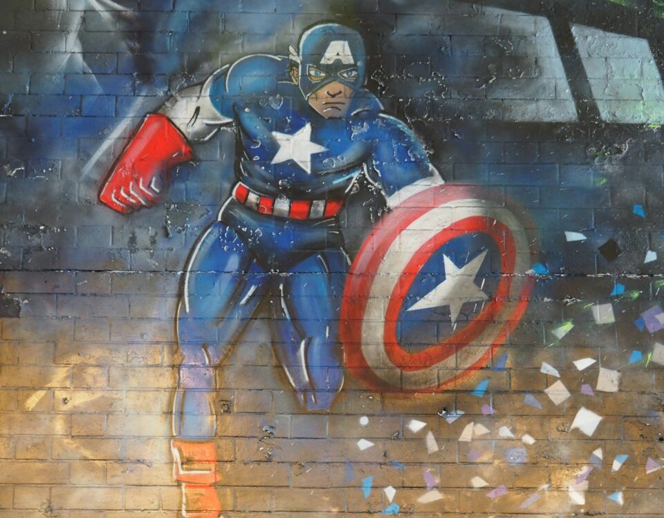 man in blue and red suit holding red and blue shield